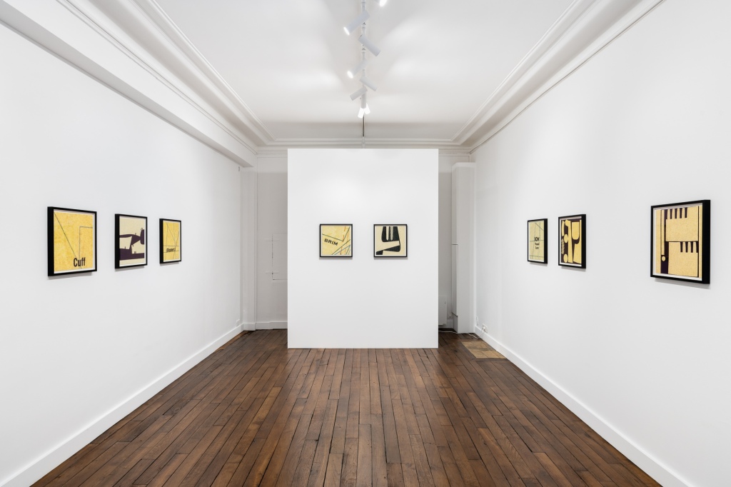 The image shows an installation view of the exhibition "the bite in the ribbon" by Erica Baum at Galerie Crèvecœure, Paris.